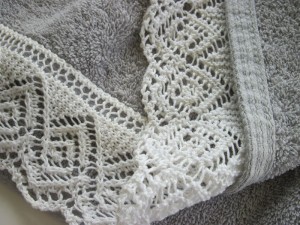 Pleasingly reversible lace edging attached to hem of towel