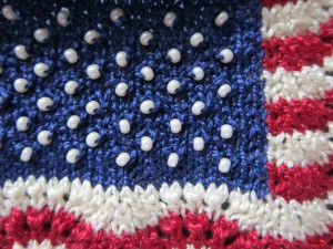 Bead stars in the miniature knitted representation of the U.S. flag