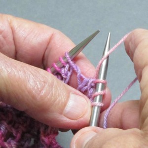 Bring yarn forward between needle points to front of work, as is usual for a yo between knit stitches.