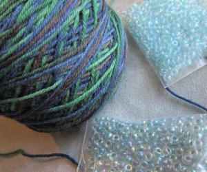 ball-of-black-watch-yarn-and-choice-of-possible-beads