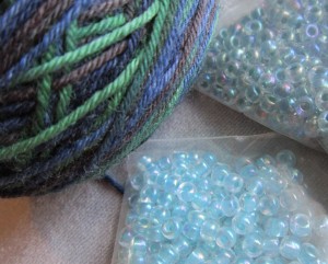 closeup-ball-of-black-watch-yarn-and-choice-of-possible-beads